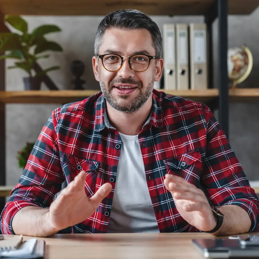 smiling-young-businessman-sit-at-desk-talk-on-webcam-having-video-call-or-conversation-with-client.webp smiling-young-businessman-sit-at-desk-talk-on-webcam-having-video-call-or-conversation-with-client.webp